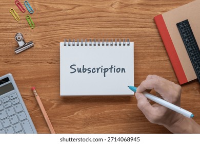 There is notebook with the word Subscription. It is as an eye-catching image.