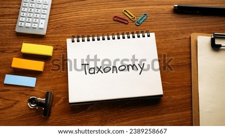 There is notebook with the word Taxonomy. It is as an eye-catching image.
