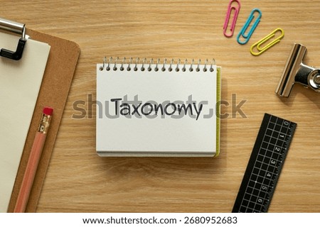 There is notebook with the word Taxonomy. It is as an eye-catching image.
