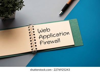 There is a notebook with the word Web Application Firewall. It is eye-catching image.