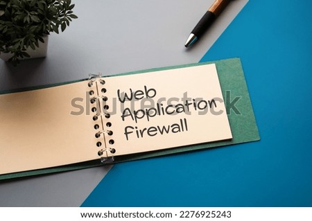 There is a notebook with the word Web Application Firewall. It is eye-catching image.