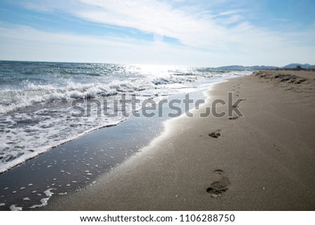 There is nothing beautiful, walking barefoot on wet sand along the sea and feeling a light foot massage. Watch how the waves roll to the shore, and water seeps through the sand, leaving a wet trace.