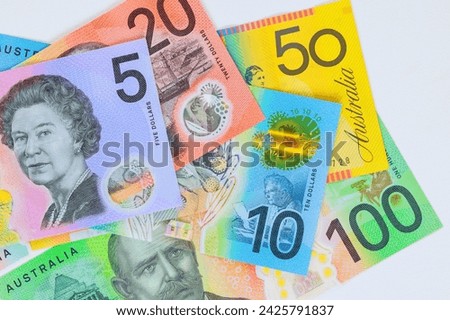 There are number of Australian AUD dollars currency banknotes with different denominations against white background.
