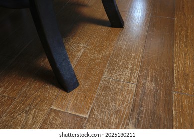 There are numerous scratches on the floor, scraped by the chair. - Shutterstock ID 2025130211