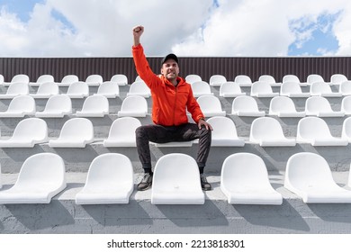 there is only one person sitting on the grandstand. He sits without a mask and looks in front of him. Quarantine. - Shutterstock ID 2213818301