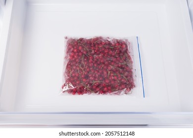 There Is A Package With Red Berries In The Freezer Drawer