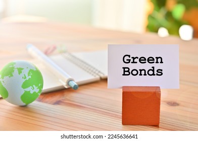 There is a piece of paper with the word Green Bonds. It is eye-catching image.