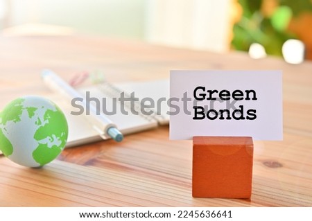 There is a piece of paper with the word Green Bonds. It is eye-catching image.