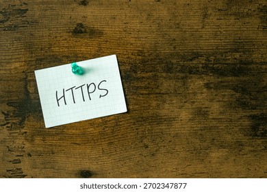 There is a piece of paper with the word HTTPS. It is an abbreviation for Hypertext Transfer Protocol Secure as eye-catching image.