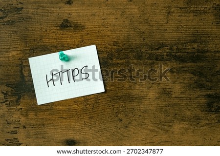 There is a piece of paper with the word HTTPS. It is an abbreviation for Hypertext Transfer Protocol Secure as eye-catching image.