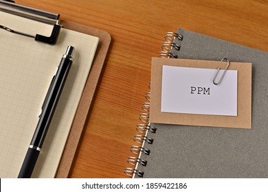 There Is A Piece Of Paper With The Word PPM Written On It. It Was An Abbreviation For Product Portfolio Management.