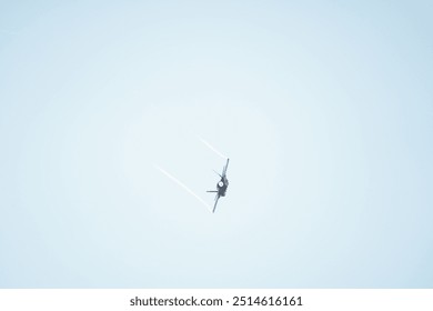 there is a plane that is flying in the sky with contrails - Powered by Shutterstock