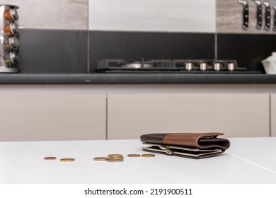 There is a purse and scattered small coins on the kitchen table. Concept: poverty and lack of livelihood, rising prices, rising rents. - Shutterstock ID 2191900511