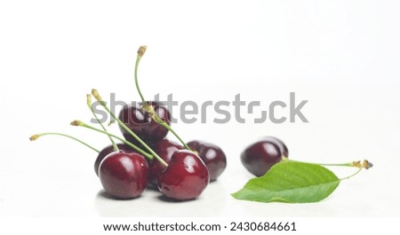                                There is a red fruit on a cherry branch on a white background