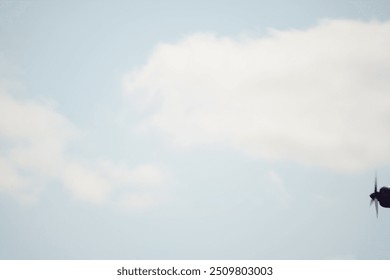 there is a small airplane flying in the sky with a propeller - Powered by Shutterstock