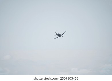 there is a small airplane flying in the sky with clouds - Powered by Shutterstock