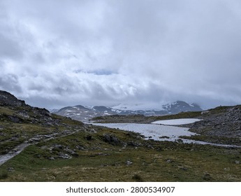 There is a small stream running through a grassy field