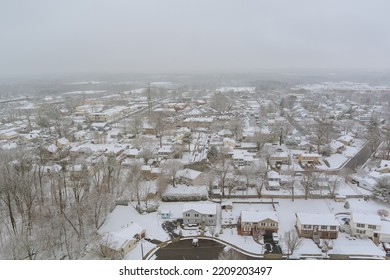 There Is Small Town In New Jersey With A House Complex Snow Covered Roof During Snowstorm During The Winter Months