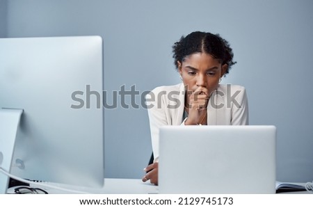There are some things the undo button cant fix. Shot of a young businesswoman using a laptop and looking anxious at her desk in a modern office.