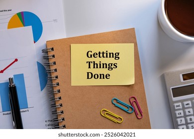 There is sticky note with the word Getting Things Done. It is as an eye-catching image.