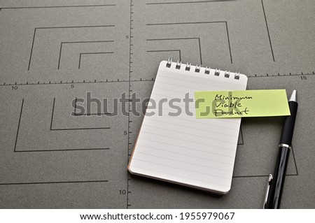 There is sticky note with the word of Minimum Viable Product on gray board.