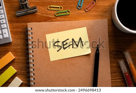 There is sticky note with the word SEM. It is an abbreviation for Search Engine Marketing as eye-catching image.