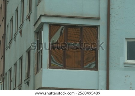 There is a structure featuring a wooden window located on one side of the building, offering a glimpse into its architectural design
