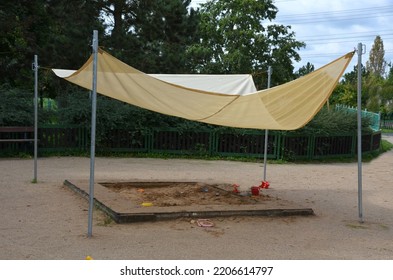 There Is A Tarpaulin Between Two Wooden Pillars. Roof Serving As A Shading For The Sandpit Or Terrace At The House Or Restaurant In The Front Garden And In The Park. Metal Wires And Cords