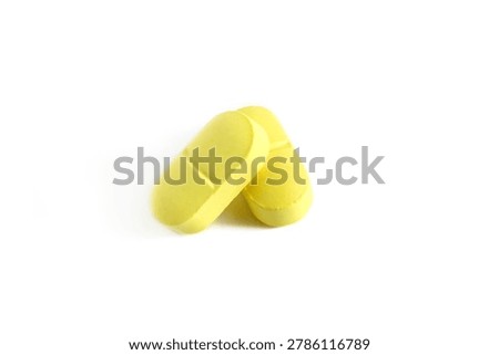 There are two oblong tablets on a white background.