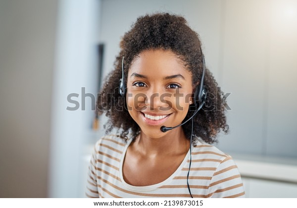 There are various ways you can get in touch.\
Portrait of a young woman wearing a headset while working on a\
computer at home.