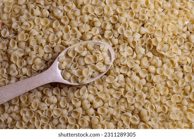 There is vermicelli and a wooden spoon on the table. Horizontal frame. - Shutterstock ID 2311289305