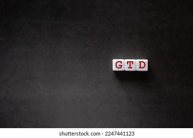There is white cube with the word GTD. It is an abbreviation for Getting Things Done as eye-catching image.