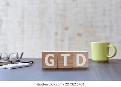 There is wood cube with the word GTD. It is an acronym for Getting Things Done an eye-catching image.