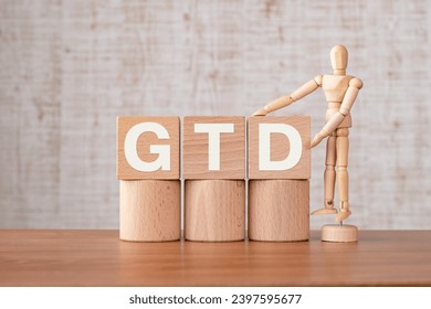 There is wood cube with the word GTD. It is an abbreviation for Getting Things Done as eye-catching image.