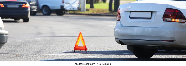 There Is Yellow Triangle Accident Sign On Road. Turn On Emergency Light And Set Emergency Parking Sign. Call Insurance Commissioner And Paperwork. Attraction Lawyer. Make Diagram An Accident