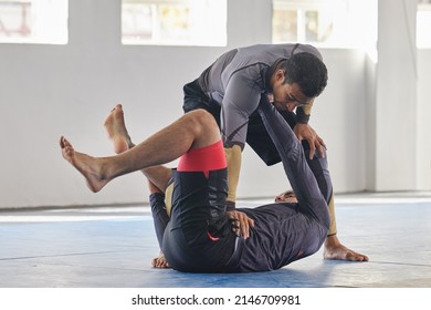 Theres A Move For Every Scenario. Full Length Shot Of A Jiu Jitsu Sensei Sparring With One Of His Students During A Class.