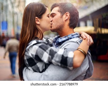 Theres Never A Bad Place For A Kiss. Shot Of A Young Couple Kissing In A Downtown Street.