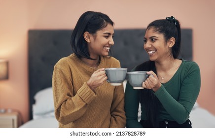 Theres no one else Id rather spill some tea with. Shot of two young women drinking coffee while sitting together at home. - Powered by Shutterstock