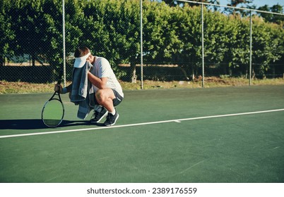 Theres no way around the hard work, so just embrace it. Shot of a sporty young man wiping his face with a towel while playing tennis on a tennis court. - Powered by Shutterstock