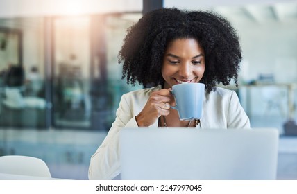 Theres Nothing Like A Cup Of Coffee To Keep You Going. Shot Of A Young Businesswoman Having A Cup Of Coffee While Doing Some Work At Her Office Desk.