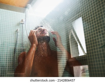Theres nothing like a rejuvenating shower. Cropped shot of a handsome young man having a refreshing shower at home.