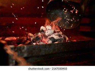 Theres nothing like the smell of a charcoal grill being fired up. Closeup shot of charcoal burning in a fireplace. - Shutterstock ID 2147030903