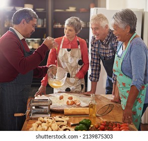 If theres a whisk, theres a way. Shot of a group of seniors cooking in the kitchen. - Powered by Shutterstock