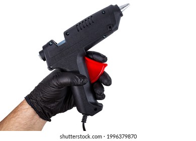 Thermal Gun With Glue In The Hand Of A Man In A Black Glove On A White Isolated