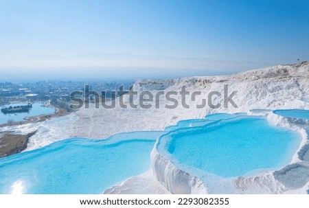 Thermal springs, natural baths Pamukkale, banner landmark of Turkey. Aerial top view blue water in travertine pool.