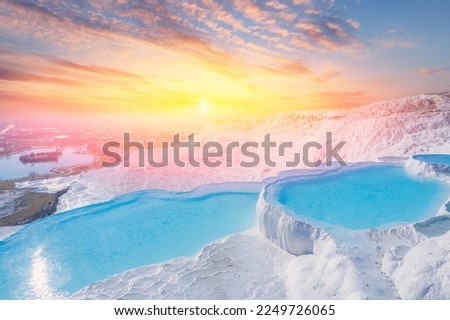 Thermal springs Pamukkale Turkey. Aerial top view sunset blue water in travertine pool.