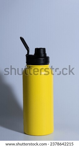 Thermo bottle isolated on white background with clipping path. Yellow Thermos Vacuum flask in the mountains Thermo flask from stainless steel for hot drinks isolated on white background Yellow Flask