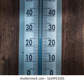 Thermometer calibrated in degrees celsius on the wooden wall, concept of world hot and weather. - Shutterstock ID 1624913101
