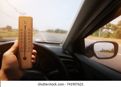 thermometer in car with hot temperature at road in Thailand