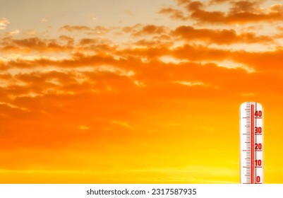 Thermometer with extreme temperature and dramatic clouds. Conceptual image symbolizing a drastic climate changes on our planet